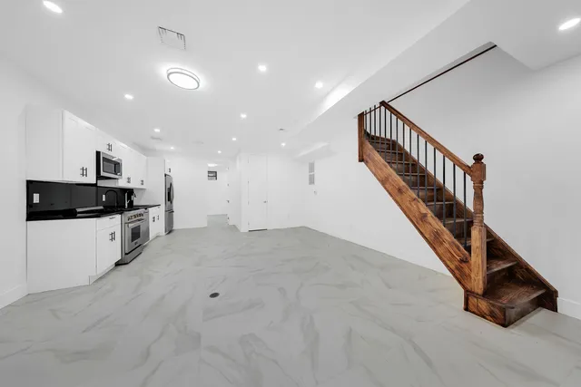a view of kitchen with microwave and stove top oven