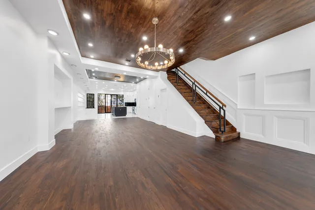 a living room with furniture and stairs