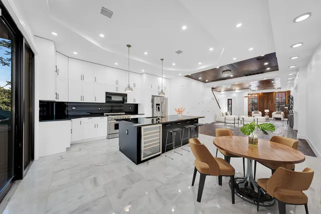 a kitchen with stainless steel appliances granite countertop a refrigerator and a stove top oven