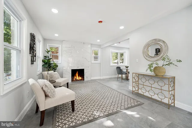 a living room with furniture a fireplace and a table