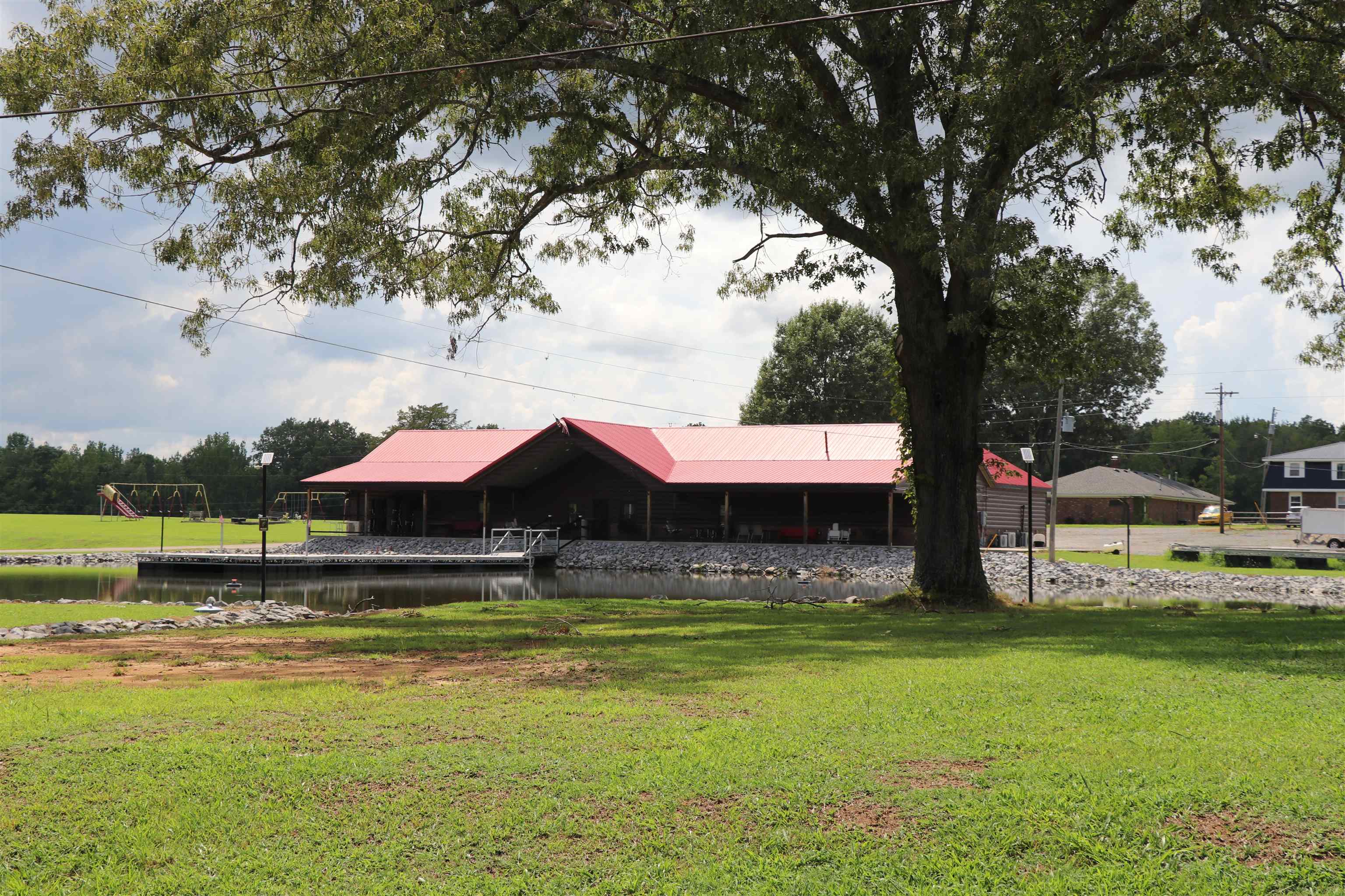 160 Patrick Drive Springville, TN 38256 - Photo 16 of 34 Waterfront structure featuring a red metal roof and an expansive covered porch