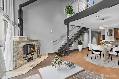 a living room with furniture a fireplace and a chandelier
