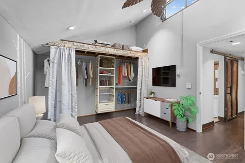 a bedroom with furniture and a flat screen tv