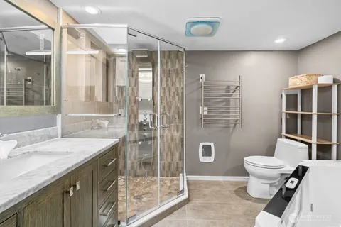 a bathroom with a sink a toilet and shower