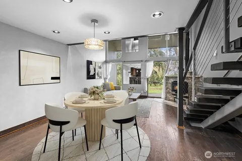 a view of a a dining room with furniture window and wooden floor