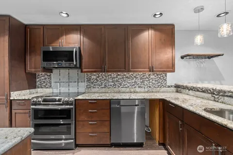 a kitchen with a sink stove and microwave