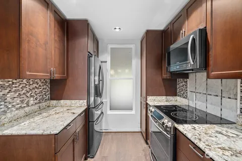 a kitchen with a stove and a refrigerator