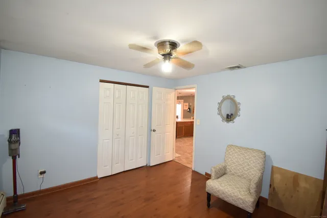 a living room with furniture and a ceiling fan