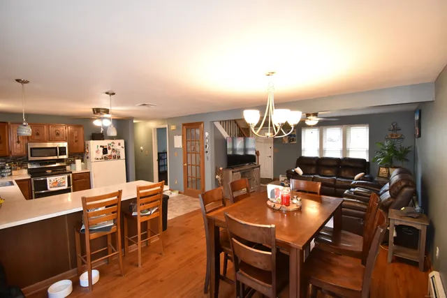 a view of a dining room with furniture and wooden floor