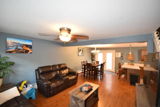a living room with furniture dining table and a large window
