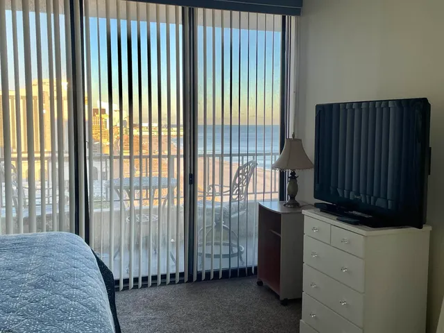 a view of a closet area with wooden floor