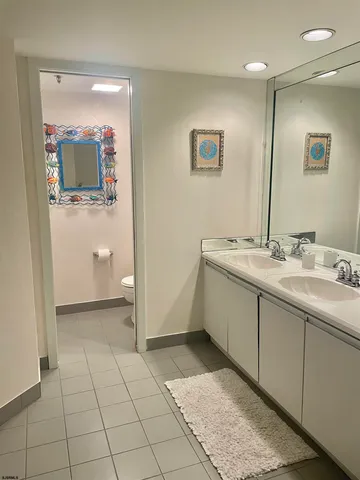 a spacious bathroom with a mirror sink and vanity