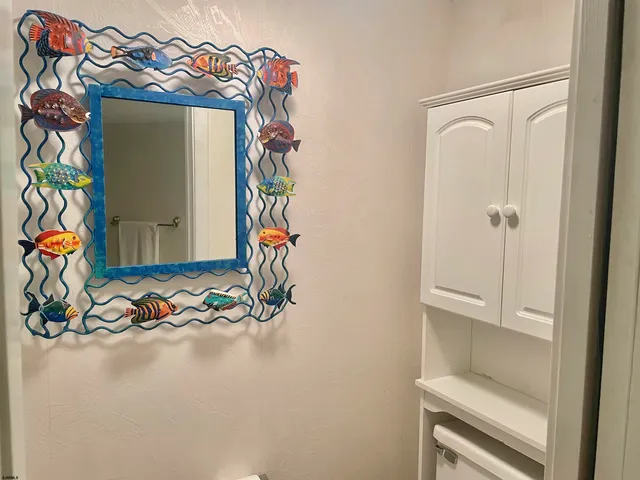 view of a room with rack on the wall and a potted plant