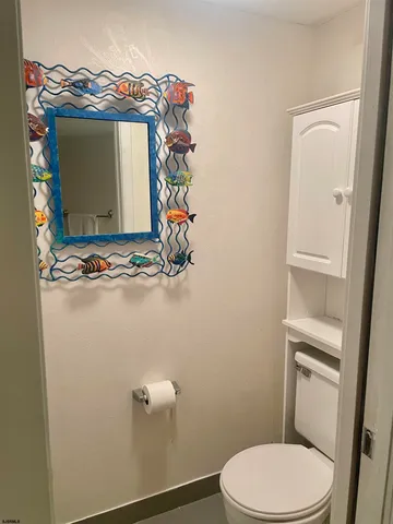 a bathroom with a toilet and a mirror