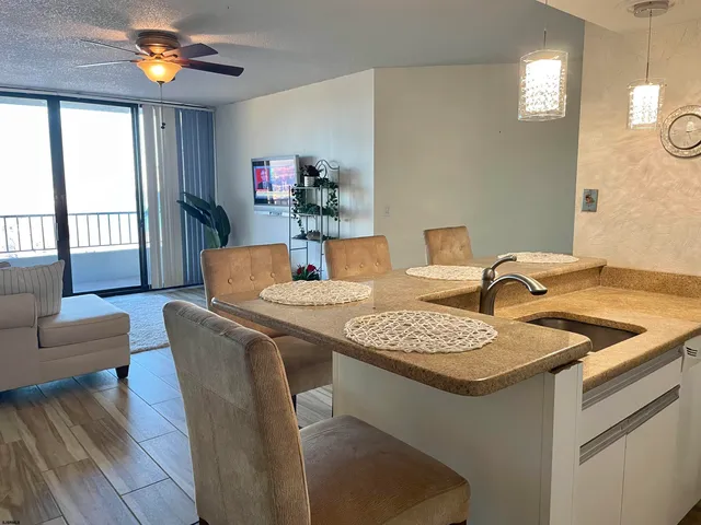 a dining room with furniture and a chandelier