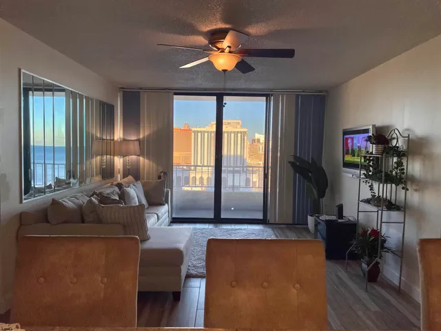 a living room with furniture and a chandelier