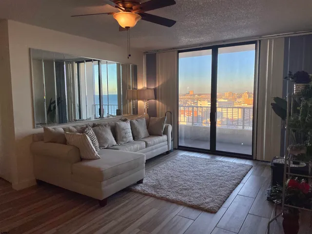a living room with furniture and a rug