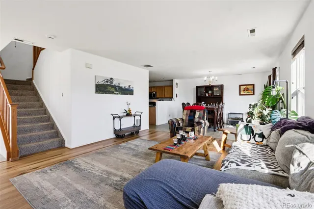 a living room with furniture and wooden floor