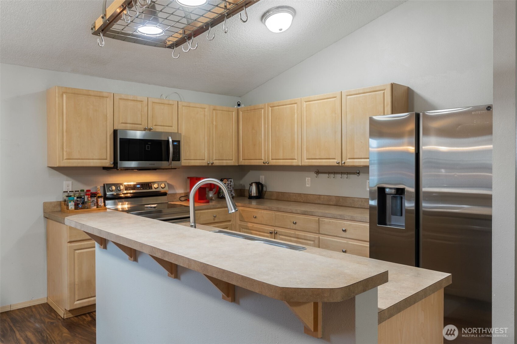 6321 199th Loop Southwest Rochester, WA 98579 - Photo 13 of 38 a kitchen with appliances a sink cabinets and a window