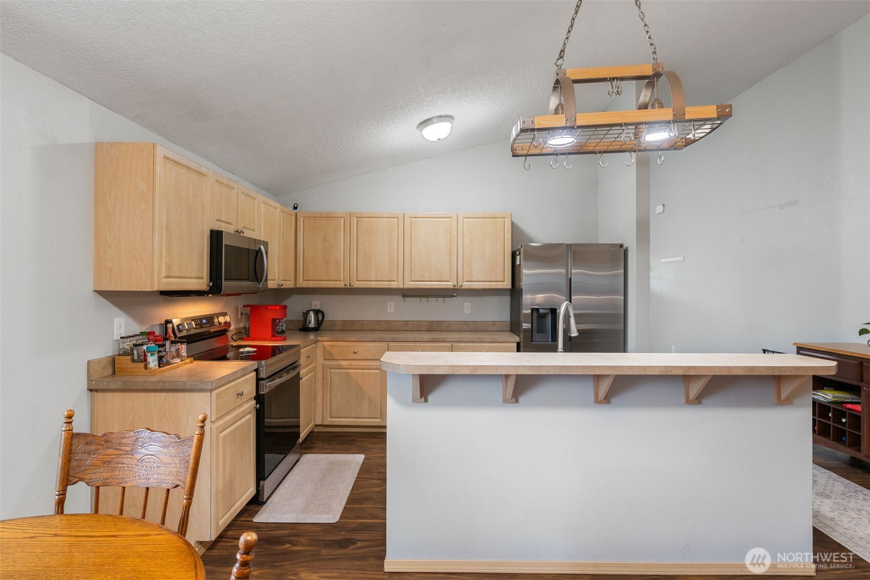 6321 199th Loop Southwest Rochester, WA 98579 - Photo 14 of 38 a kitchen with a sink a stove and cabinets