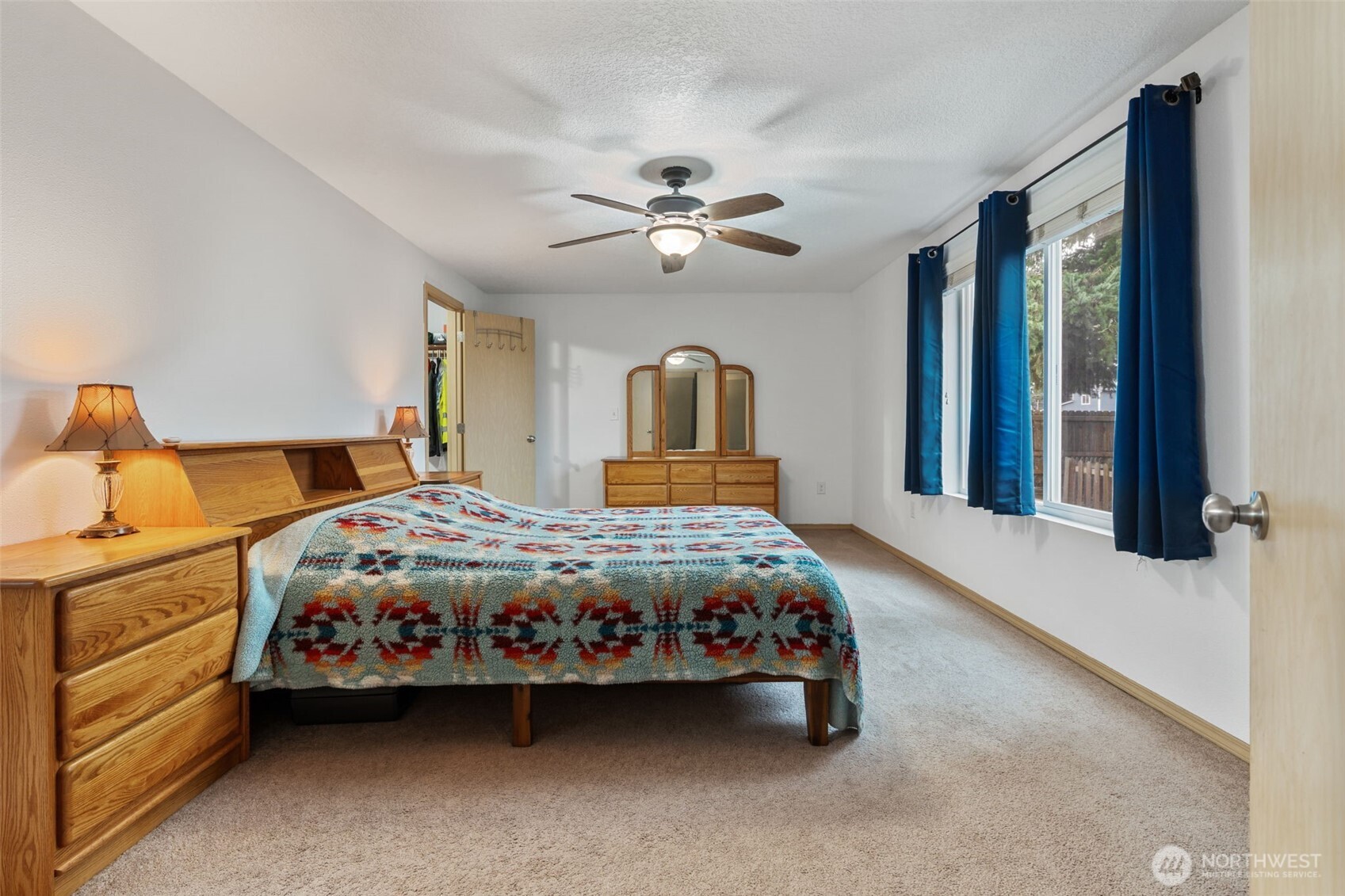 6321 199th Loop Southwest Rochester, WA 98579 - Photo 20 of 38 a bedroom with a bed and a chandelier