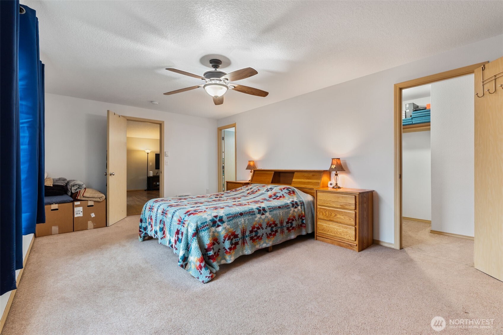 6321 199th Loop Southwest Rochester, WA 98579 - Photo 21 of 38 a spacious bedroom with a bed and a chandelier