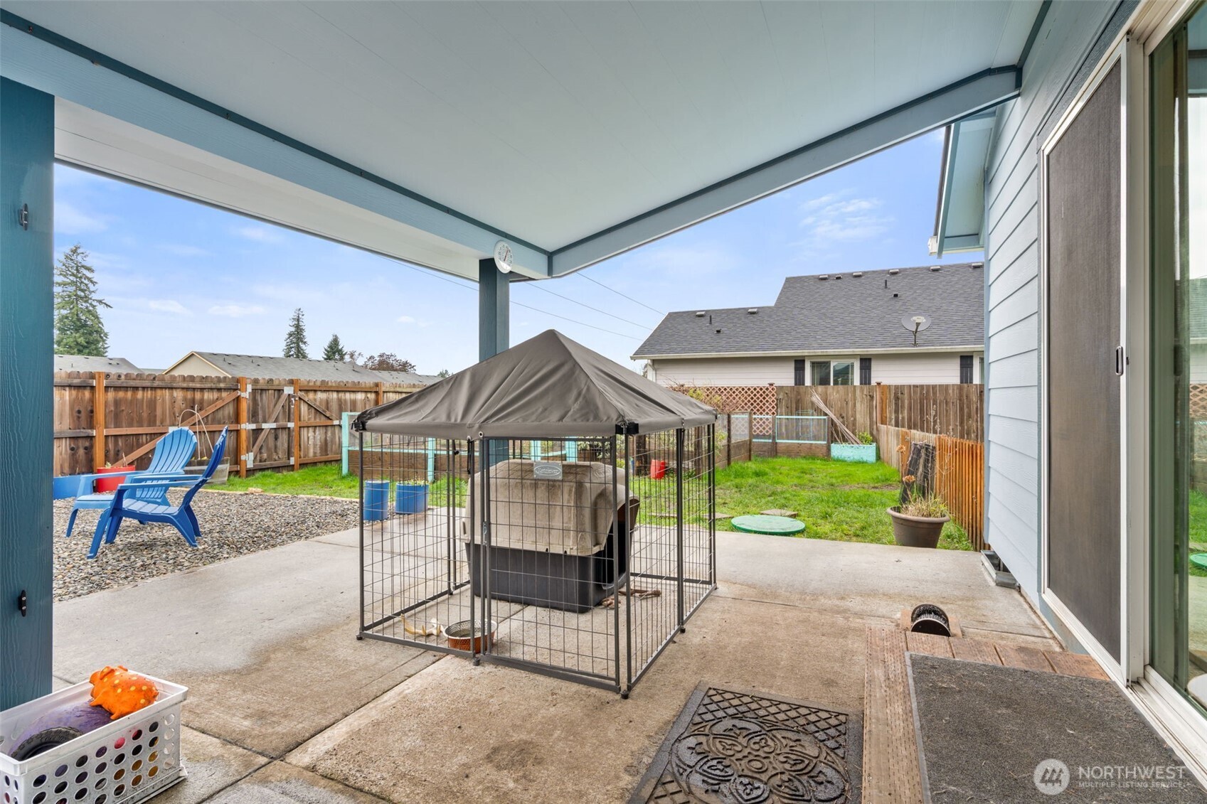 6321 199th Loop Southwest Rochester, WA 98579 - Photo 28 of 38 a view of a patio with a dining table and chairs under an umbrella