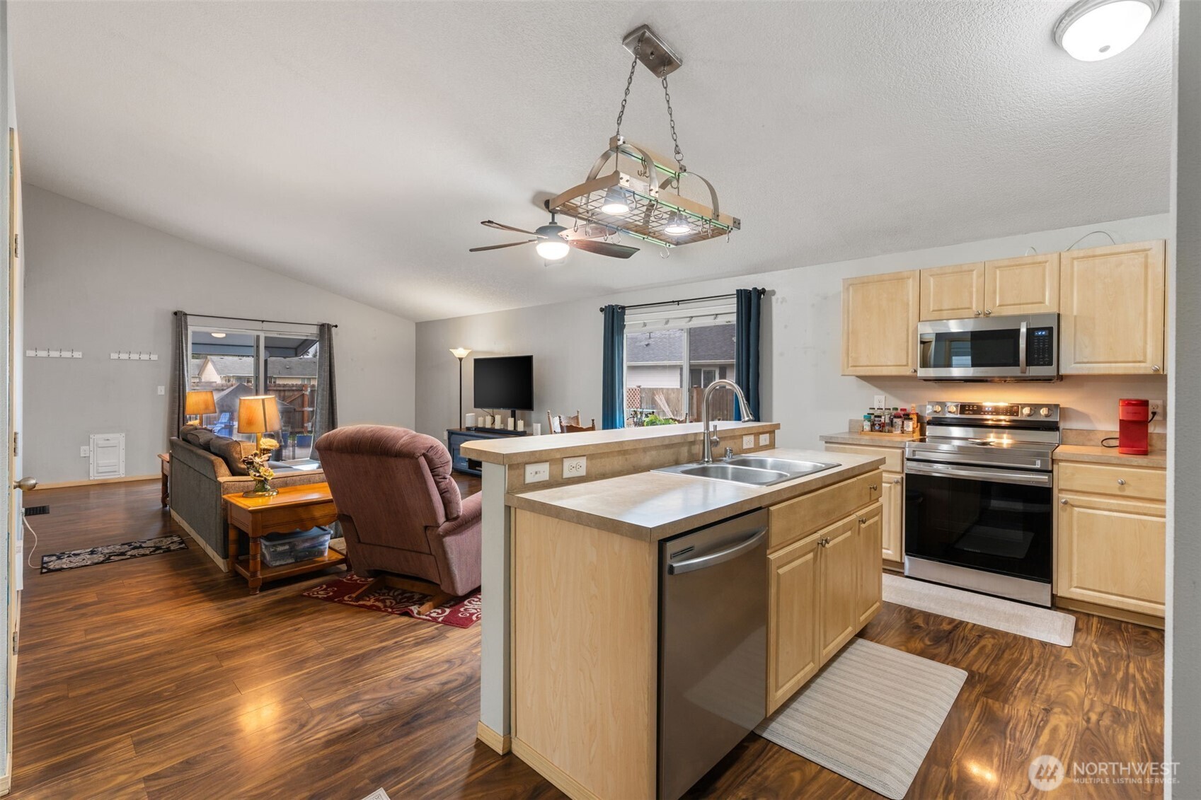6321 199th Loop Southwest Rochester, WA 98579 - Photo 9 of 38 a open kitchen with stainless steel appliances granite countertop a stove and a refrigerator