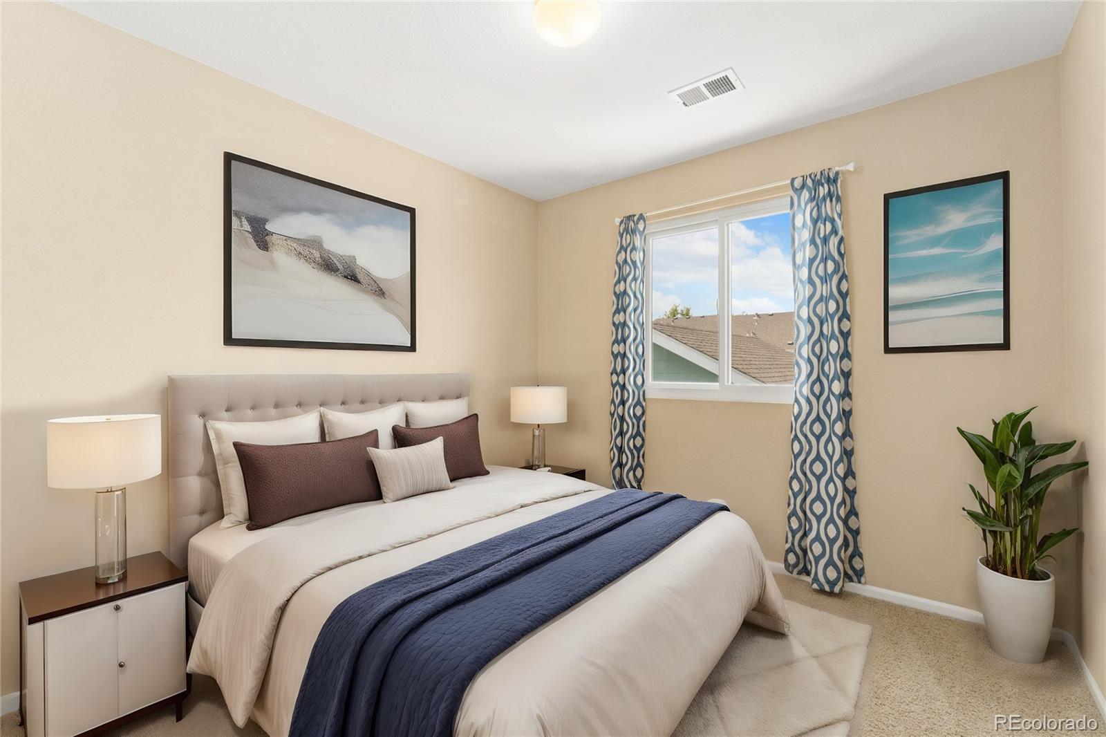 5831 Ceylon Street Denver, CO 80249 - Photo 11 of 14 a bedroom with bed and a painting on the wall