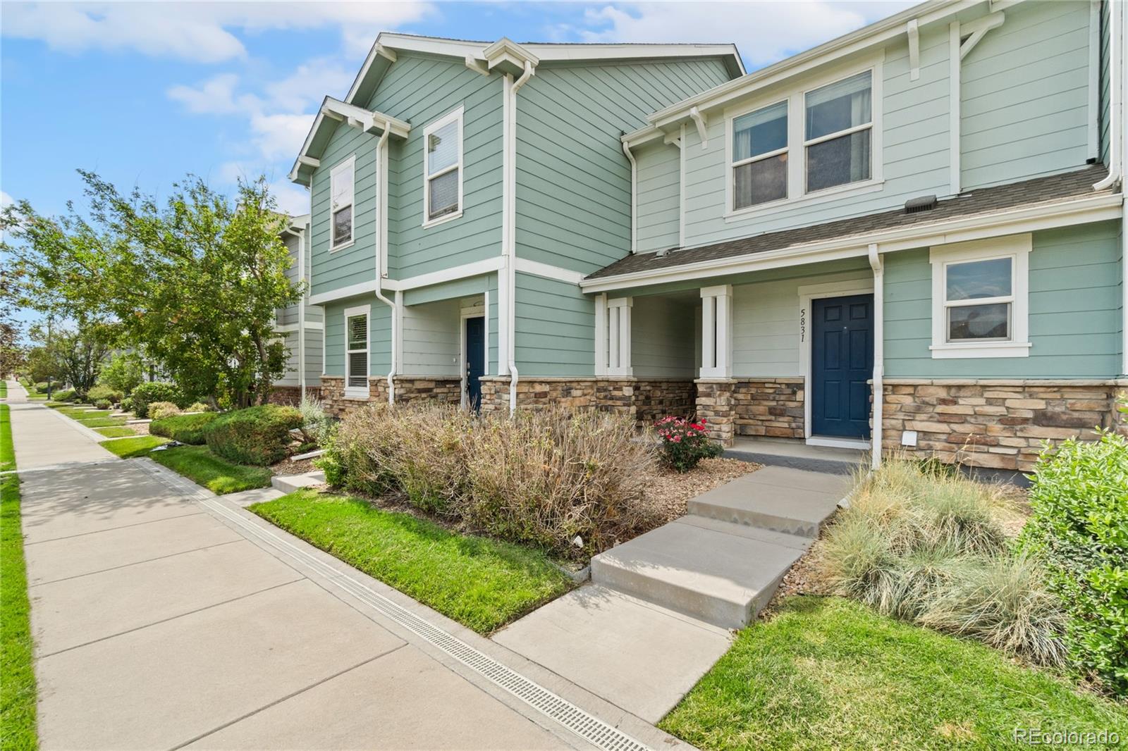 5831 Ceylon Street Denver, CO 80249 - Photo 2 of 14 front view of a house with a yard