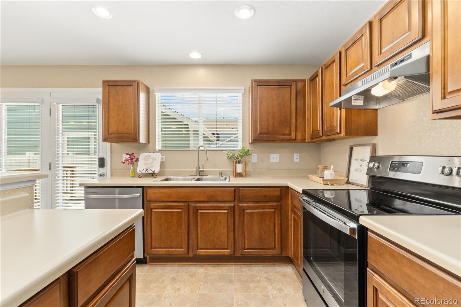 5831 Ceylon Street Denver, CO 80249 - Photo 3 of 14 a kitchen with a sink stove and cabinets