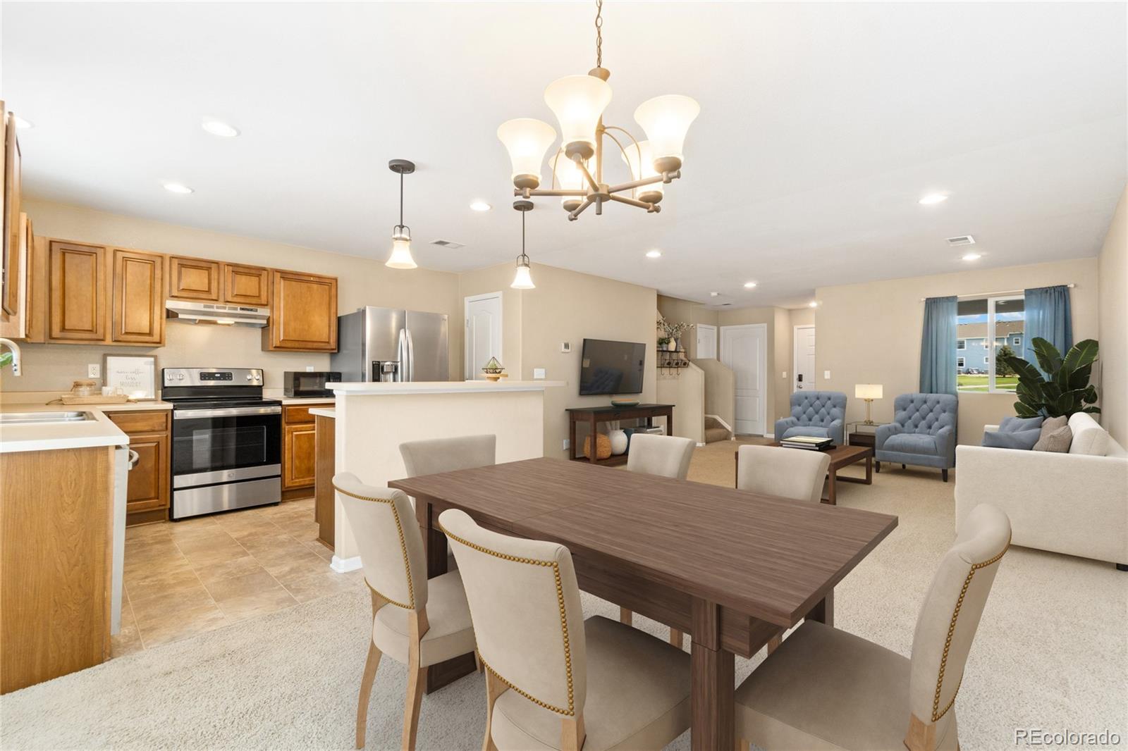 5831 Ceylon Street Denver, CO 80249 - Photo 4 of 14 a large kitchen with a table and chairs