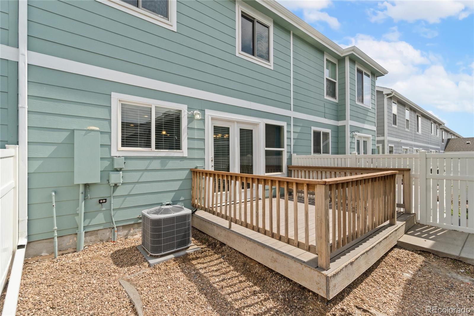 5831 Ceylon Street Denver, CO 80249 - Photo 6 of 14 a view of a house with a small yard and wooden floor and fence