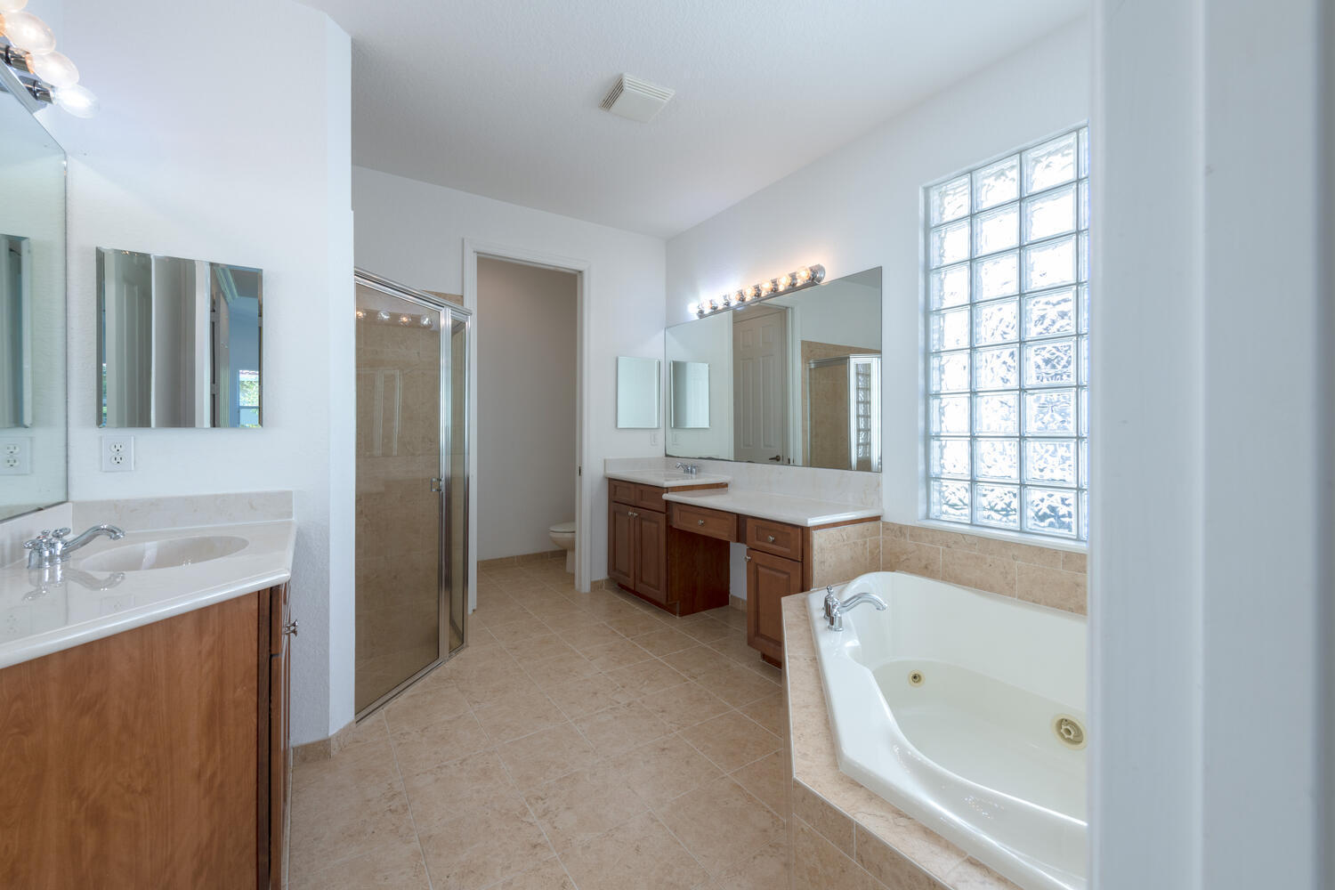 754 Aberfoyle Avenue Fort Pierce, FL 34947 - Photo 11 of 19 a bathroom with a tub sink double vanity granite tub shower and mirror