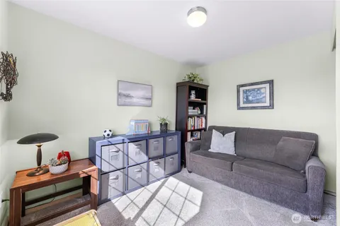 a living room with furniture and a floor to ceiling window