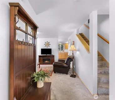 a living room with furniture potted plant and a window