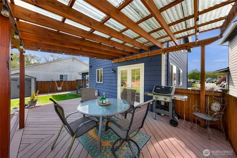 a view of a house with a backyard and a patio