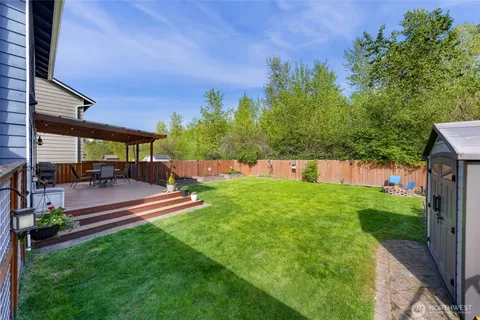 a view of a house with a yard patio and fire pit