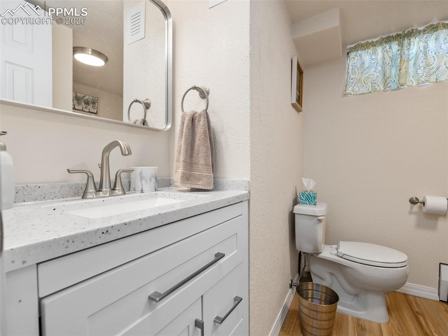 20 Robertson Road Pueblo, CO 81001 - Photo 23 of 39 Bathroom with light wood-type flooring, vanity, and a textured wall