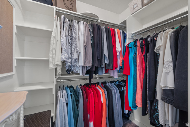955 Delorean Lane Midvale, UT 84047 - Photo 23 of 47 Custom closet system featuring white shelving, multiple hanging rods, and integrated storage solutions