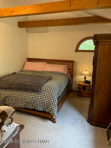 a bed sitting in a bedroom next to a window