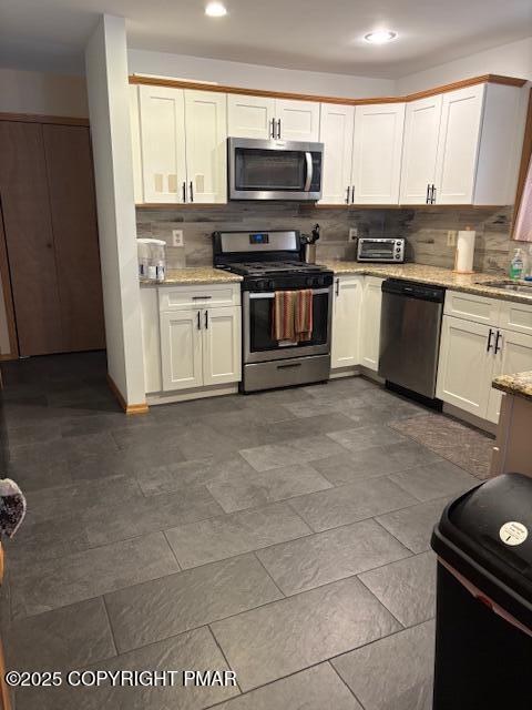 893 Millcreek Road Newfoundland, PA 18445 - Photo 6 of 31 a kitchen with stainless steel appliances granite countertop a stove a sink and a microwave