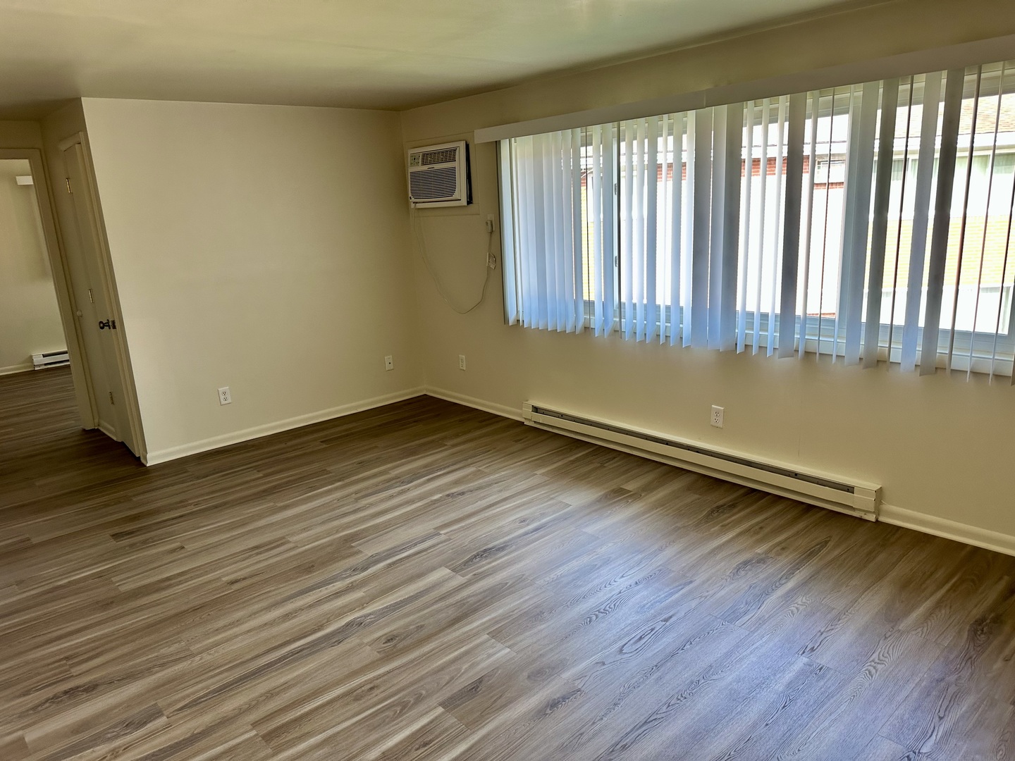1735 East Duane Boulevard, Unit 4 Kankakee, IL 60901 - Photo 2 of 6 a view of a room with wooden floor and a window