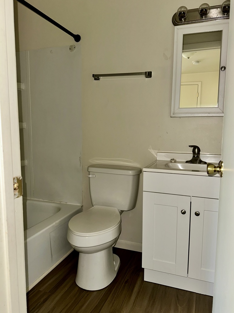 1735 East Duane Boulevard, Unit 4 Kankakee, IL 60901 - Photo 4 of 6 a bathroom with a sink a toilet and shower