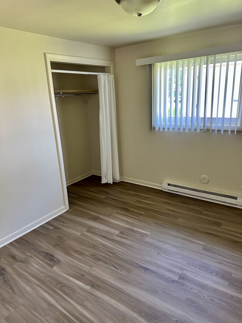 1735 East Duane Boulevard, Unit 4 Kankakee, IL 60901 - Photo 6 of 6 a view of empty room with wooden floor and fan