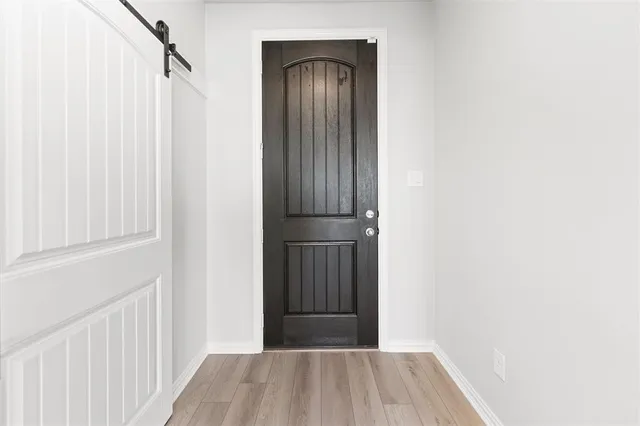 a view of a hallway with wooden floor