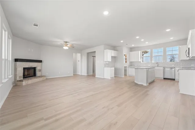 a view of kitchen with wooden floor and electronic appliances