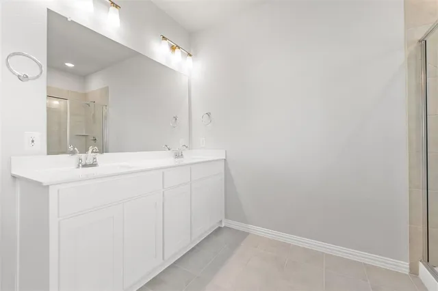 a bathroom with a sink vanity and a mirror