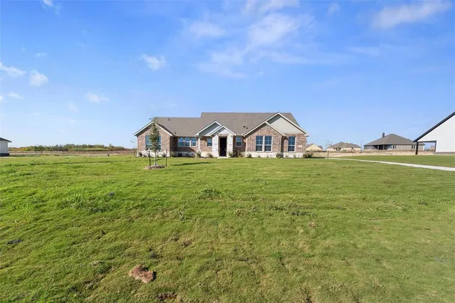 a view of a field with an ocean view