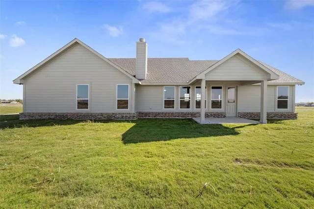 a view of a house with a yard patio and swimming pool